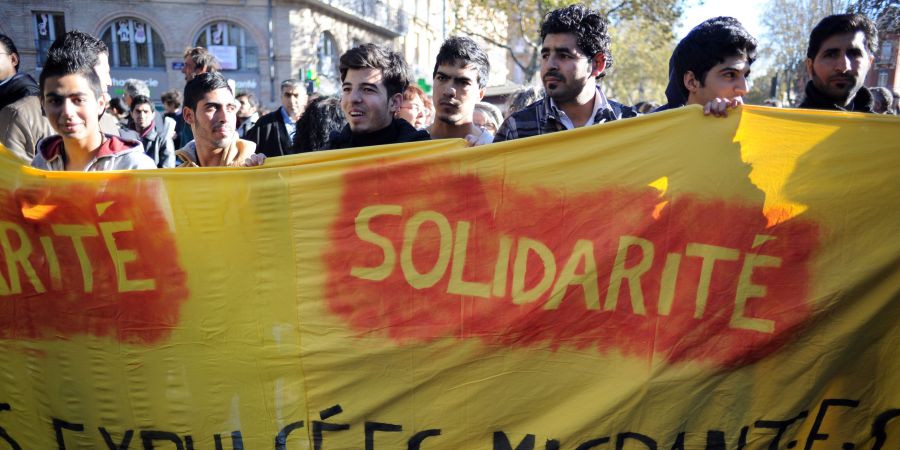 People take part in a silent walk to support freedom and peace and ag