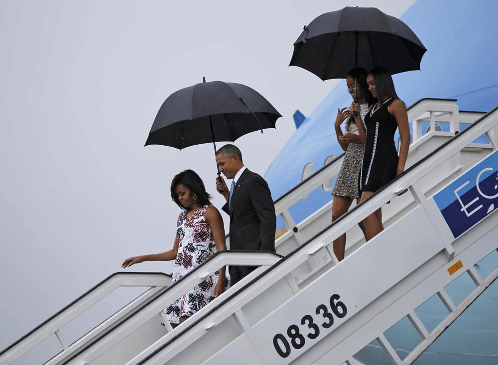 U.S. President Barack Obama and his wife Michelle exit Air Force One at Havana's airport