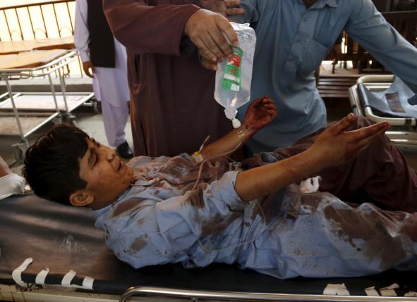 A boy injured during a suicide attack in Shabqadar is transported on a strecher at Lady Reading hospital in Peshawar