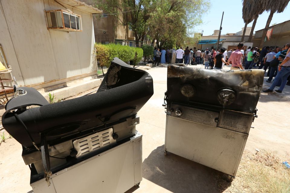 Burnt incubators stand outside Yarmuk ho