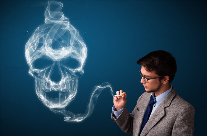 Young man smoking dangerous cigarette with toxic skull smoke